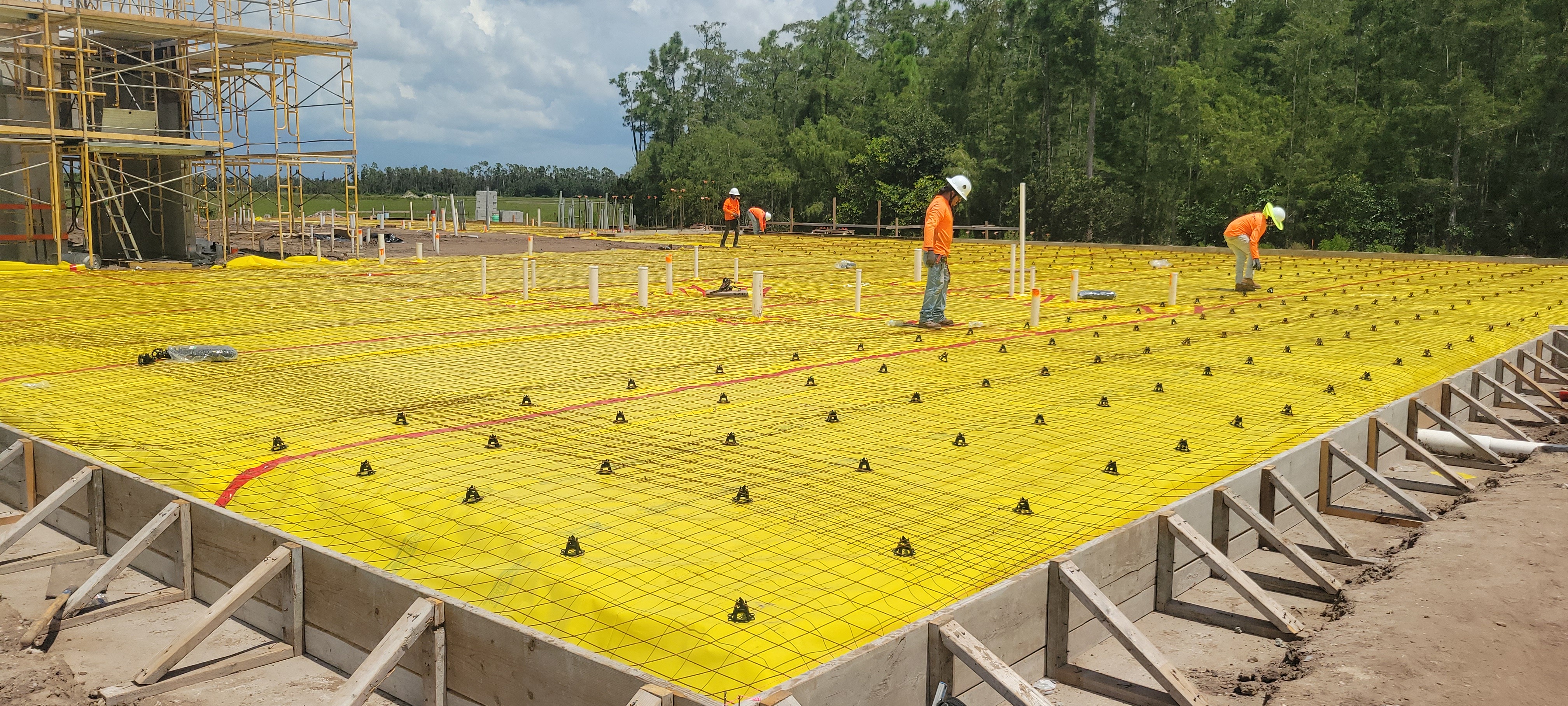 Workers and slab preparation at the Palms Manor site
