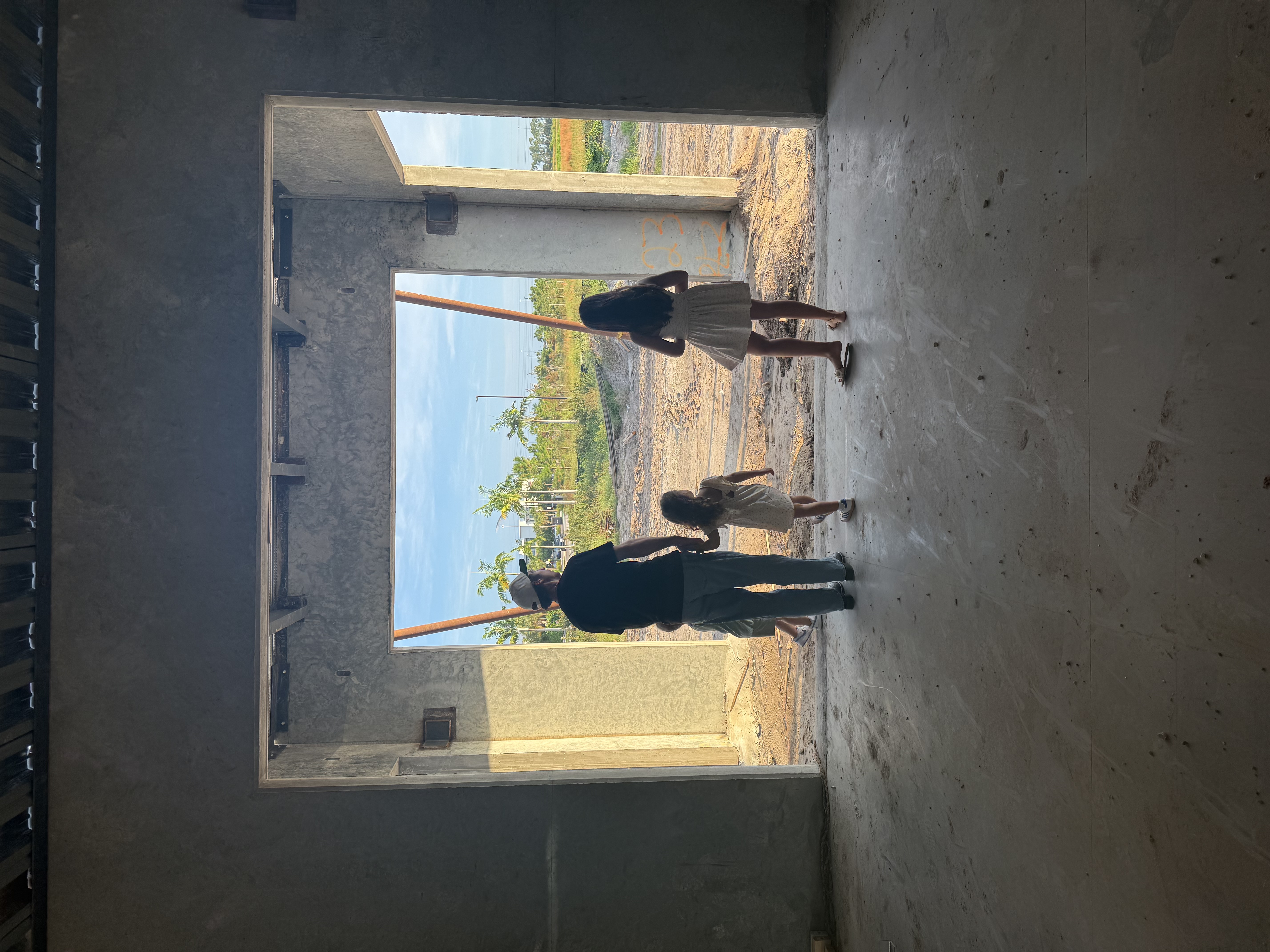 Family walking through an unfinished doorway at Palms Manor