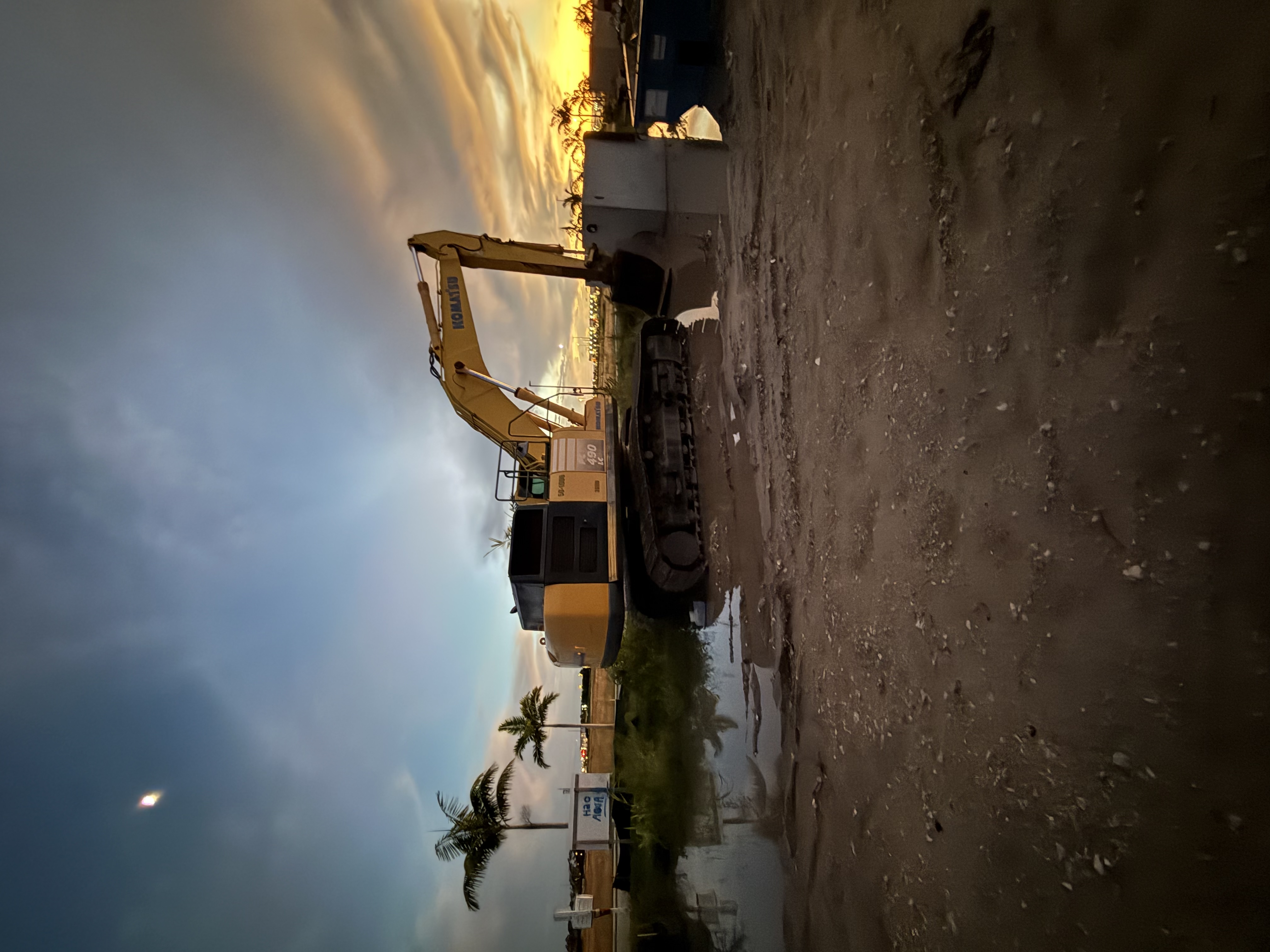 Excavator at the Palms Manor site at sunset