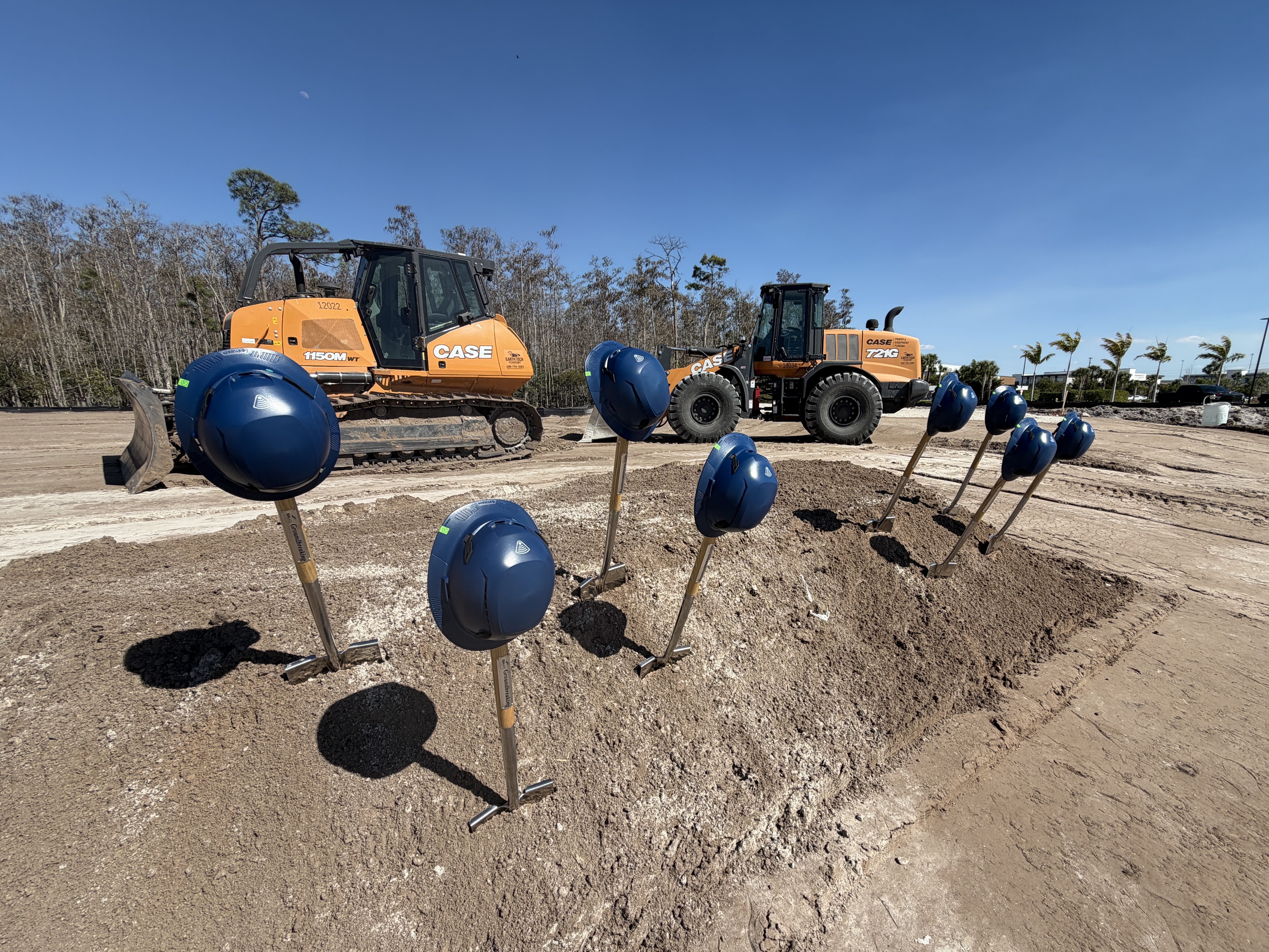 Earthmoving equipment and ceremonial shovels at the Palms Manor groundbreaking